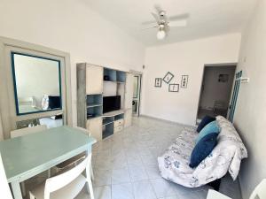 a living room with a couch and a table at Casa Cicì a 50 mt dal mare nel budello di Finale in Finale Ligure