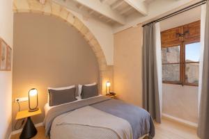 a bedroom with a bed and a large window at Hotel Can Cirera in Palma de Mallorca