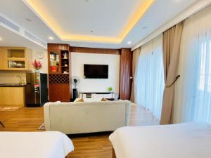a living room with two beds and a couch at FLC SEA TOWER - Quy Nhơn in Quy Nhon
