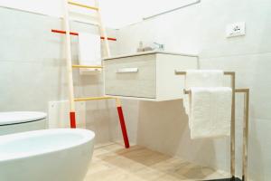 a bathroom with a white toilet and a sink at 16Miglia in La Caletta +27 photos