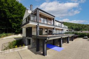 a house on a pier with a balcony at APARTAMENT8 Wellness Sauna View 5os in Szczyrk