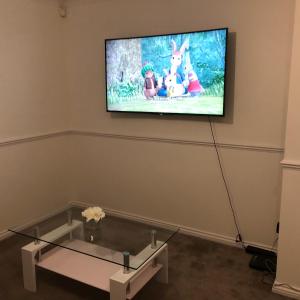 a room with a flat screen tv on a wall at Lovely 3-Bed House in Chafford Hundred in North Stifford
