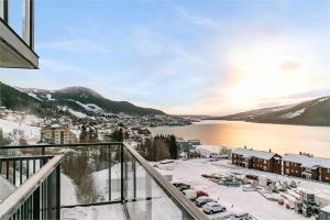 a balcony with a view of a parking lot with snow at Åre Travel - View in Åre