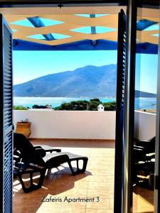 a view of the ocean from the balcony of a house at Zafeiris Apartments in Livadia