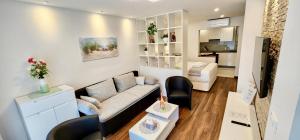 a living room with a couch and a tv at Comfort Studio Bella Lucia in Portorož