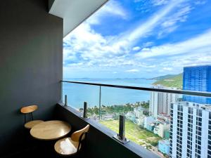 a room with a balcony with a view of the ocean at FLC SEA TOWER - Quy Nhơn in Quy Nhon
