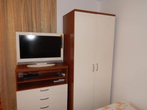 a tv on a cabinet with a television on it at Apartment Petrova in Zagreb