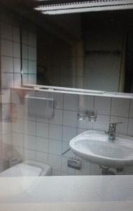 a bathroom with a sink and a toilet at Gästezimmer in Zurich
