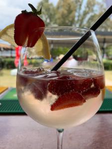 a drink with a strawberry on top of it at Yücel Hotel in Fethiye