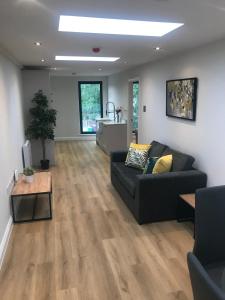 a living room with a couch and a table at Heart of Henley 1 & 2 Bedroom Apartments in Henley on Thames