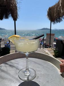 a drink sitting on a table with a view of the ocean at Yücel Hotel in Fethiye
