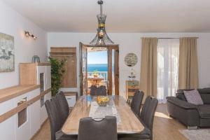 a living room with a dining room table and chairs at Apartment J&J in Makarska