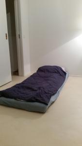 a bed sitting on the floor in a room at Gästezimmer in Zurich