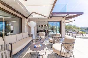 a living room with a couch and chairs at Villa Paulina MOUGINS in Mougins