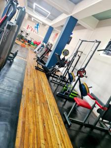 a gym with tread machines and a wooden floor at Апарт-отель Nine Rooms in Yerevan