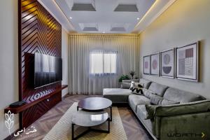 a living room with a couch and a tv at Khozama AlNahda in Jeddah
