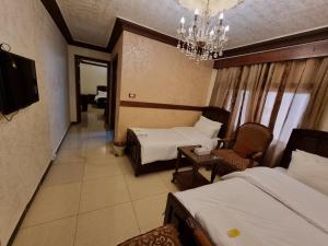 A bed or beds in a room at Nahas Plaza