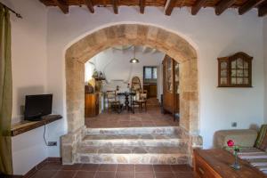 an archway leads into a living room and dining room at Secret Garden, a little paradise of tranquility. in Lépidha