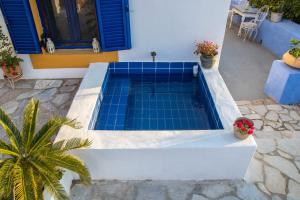 a swimming pool with blue tiles in a house at Secret Garden, a little paradise of tranquility. in Lépidha