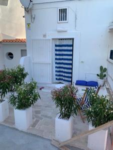a white garage with potted plants in front of it at Borghetto Sul Mare in Peschici