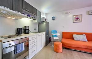 uma cozinha com um sofá laranja numa cozinha em Cozy Home In Tuheljske Toplice With Kitchen em Tuheljske Toplice