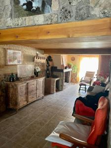 a living room with a couch and a table at Cortijo de las cañadas in Venta de Mendoza