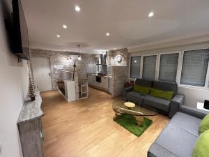 a living room with a couch and a table at Rentxacobeo in Sarria