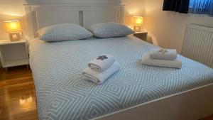 a bedroom with a bed with towels on it at Apartment Lea in Trogir