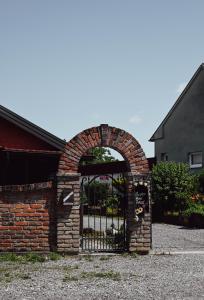 an entrance to a brick building with an iron gate at Studio Apartment Romeo in Velika Gorica