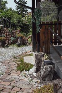 a garden with a stone walkway with a potted plant at Studio Apartment Romeo in Velika Gorica