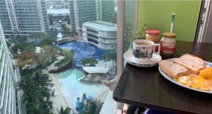 a table with a plate of food and a cup of coffee at Azure Urban Resort in Manila +164 photos