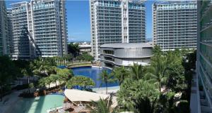 a view of a pool in a city with tall buildings at Azure Urban Resort in Manila