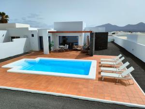 a swimming pool on the roof of a house at Villalia Aroa in Playa Blanca