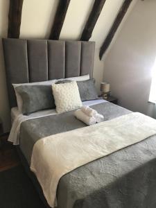 a large bed with a stuffed animal on top of it at Pomona Lodge in Kempton Park