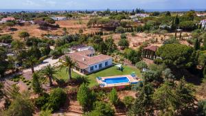 an aerial view of a house with a swimming pool at Luxury Villa With Pool in Vineyard Near the Beach in Porches