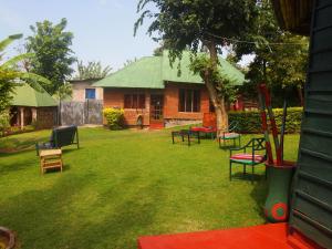 a group of chairs in a yard with a house at Songota Falls Lodge in Arusha