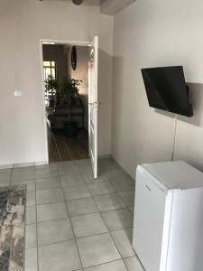 a living room with a tv on a wall at Pomona Lodge in Kempton Park