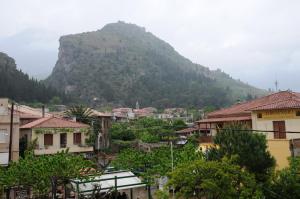 a city with a mountain in the background at Byzantion Hotel in Mystras