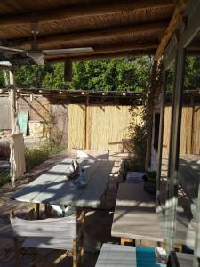 a group of chairs and tables under a pergola at Latmos 1860 in Skala