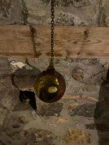 a bird bath hanging from a chain on the ground at Latmos 1860 in Skala
