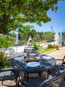 a table with a plate of food on it at Cozy Algarve Home with Vineyard View Near Beaches in Porches