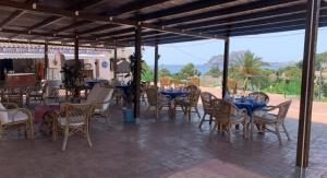 a group of tables and chairs with blue tables and chairs at Hotel Restaurant Baladrar in Benissa