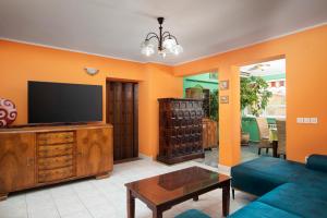 Una sala de estar con un sofá y un televisor. en Villa Arena - pool table, table tennis, darts & more, en Pula