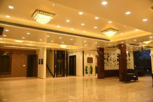 a large room with a lobby with lights on the ceilings at RIVERSIDE MEADOWS in Vidisha