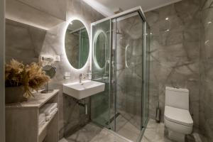 a bathroom with a shower and a toilet and a sink at Mansion House Parga in Parga +49 photos