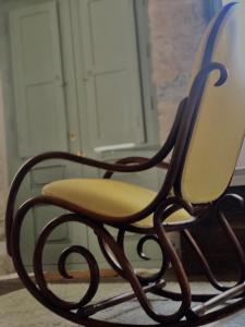 a chair sitting in front of a door at Latmos 1860 in Skala
