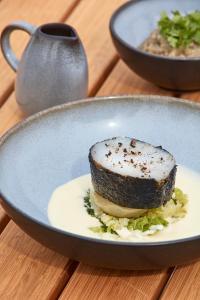 a plate with a piece of food on a table at Les Hautes Mers in L'Ile d'Yeu