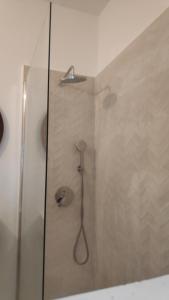 a shower with a shower head in a bathroom at Ocean front La Maresia Holiday 2 Apartments in Taganana