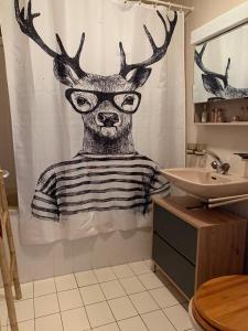 a painting of a deer in a shower curtain in a bathroom at Studio Hauts-de-Nendaz G2 ski in-out in Nendaz