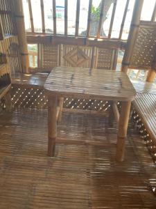 a wooden bench sitting on top of a wooden floor at Golden Kirins Beach Resort in Lian